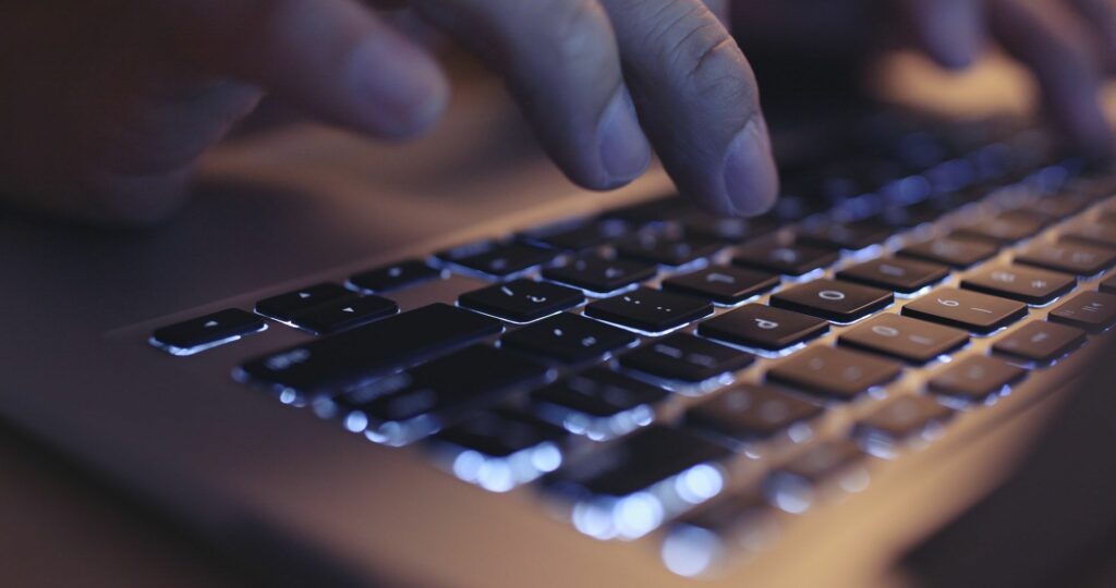 Fingers typing on keyboard