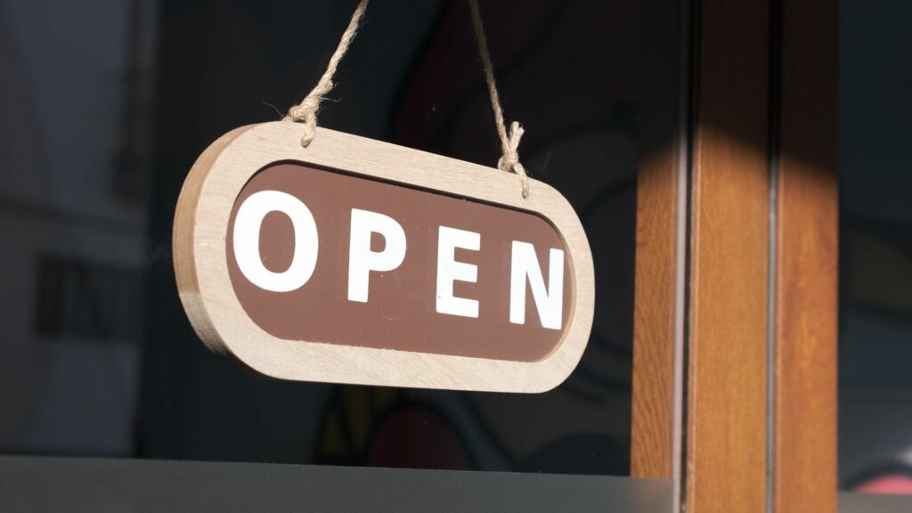 Small business opening up. Turning the sign to open